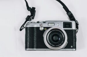 Close-up image of a vintage-style camera, showcasing its lens and details.