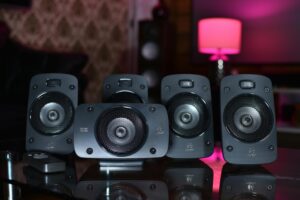A close-up of a surround sound speaker system with remote, perfect for modern home entertainment.
