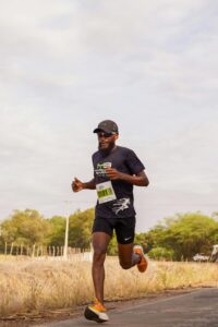 Athlete running outdoors in a marathon, showcasing endurance and determination.