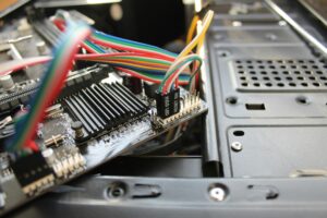 Close-up view of a motherboard with colorful wires and electronic components, showcasing intricate details.