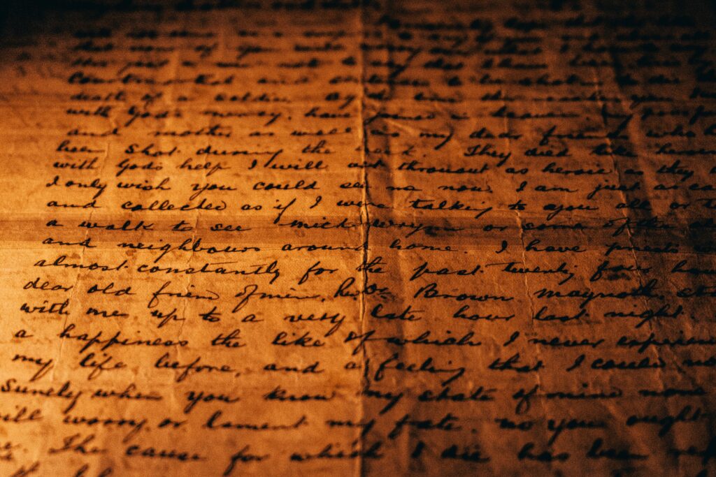 Close-up view of a vintage handwritten letter on textured aged paper.