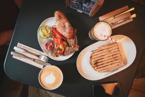 A top view of a delicious sandwich and coffee at an Italian café, showcasing fresh ingredients and cozy atmosphere.
