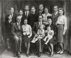 Classic family portrait featuring multiple generations in black and white.
