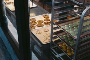 Trays of freshly baked cookies including chocolate chip and sprinkle in a Seattle bakery display.