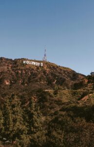 Scenic view of the Hollywood Sign on a sunny day in Los Angeles, capturing the famous landmark and surrounding hills.