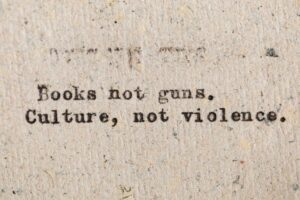 A vintage typewritten quote promoting culture over violence on aged paper.