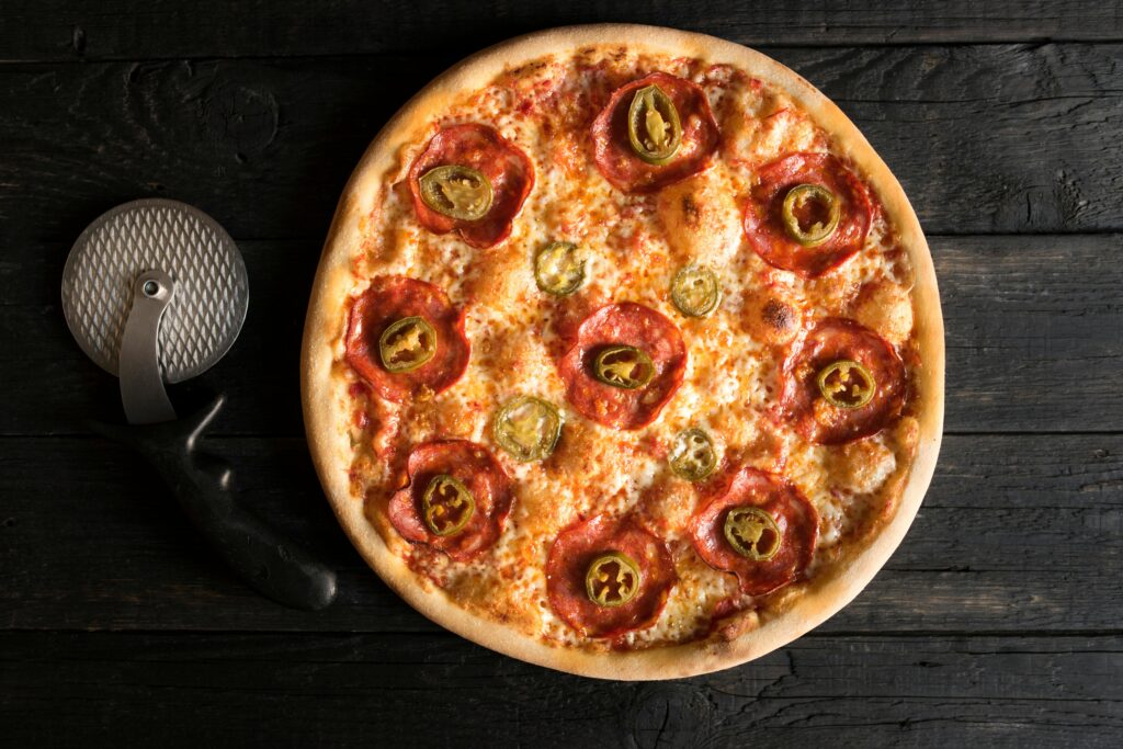 Delicious pepperoni pizza topped with spicy jalapeños and melted cheese.