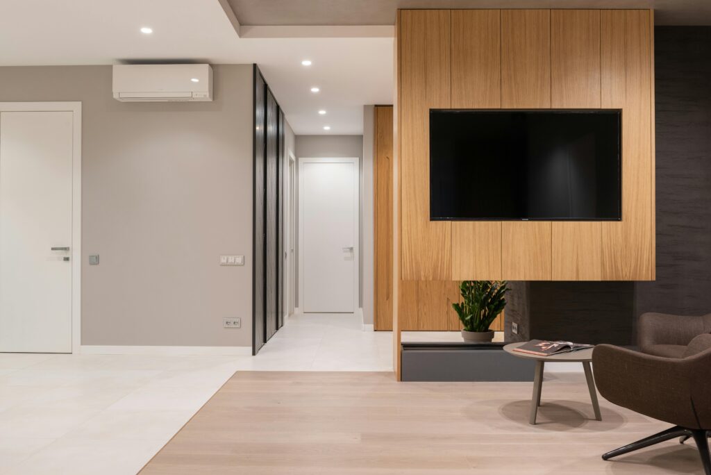 Spacious modern living room with minimalist decor and wooden accents.