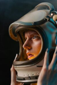 A striking close-up of an astronaut in a helmet, highlighted by neon lighting for a futuristic feel.