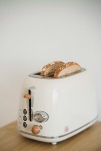 Classic white toaster with toasted sesame seed bread ready to enjoy.