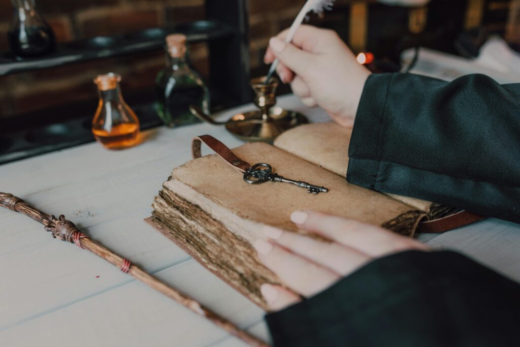 Mystical setup with a quill, spell book, and magical potions.
