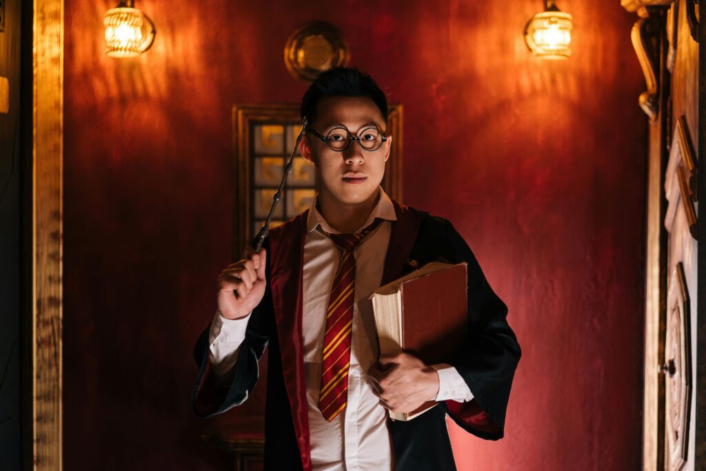 Portrait of a man in wizard attire holding a wand and book, inspired by fantasy themes.