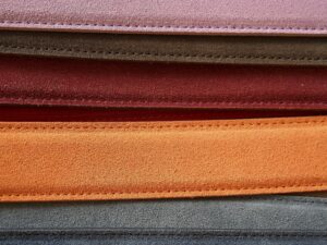 Close-up of colorful leather belts showcasing detailed stitching.