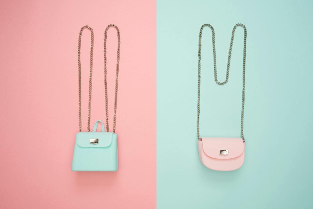 Stylish pastel handbags on pink and mint split backgrounds, perfect for fashion and design themes.