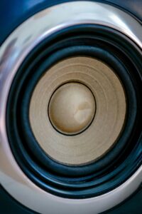 Detailed macro view of a round speaker cone showcasing sound technology.