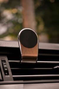 Close-up of a metallic magnetic phone holder on car air vent.