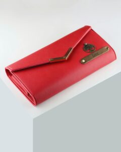 Sleek red leather wallet with embellishments for stylish fashion statement.