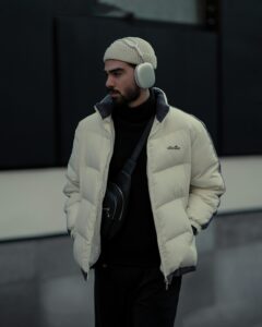 Urban fashion photo showcasing a stylish man with winter accessories and modern attire.