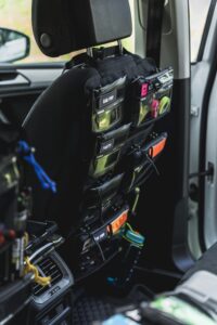 Car interior showcasing various storage bags on the backseat, ideal for organization.