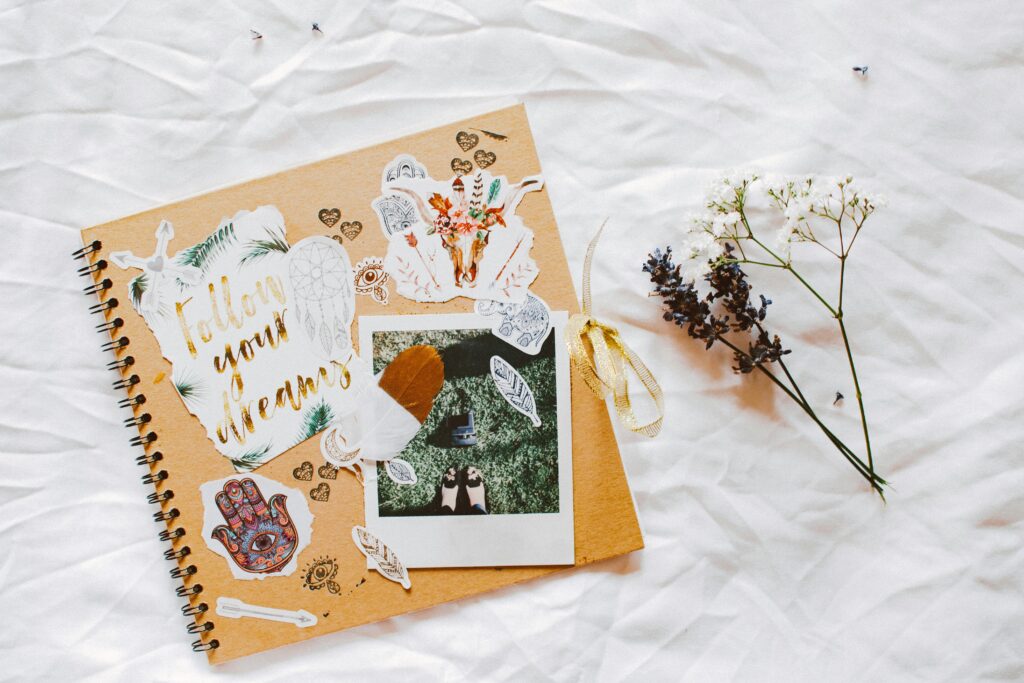 A dreamy scrapbook layout with floral decorations and motivational cutouts.