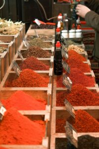 Vibrant spices stacked in a traditional market, showcasing a variety of textures and colors.