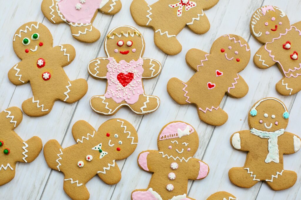 A delightful assortment of decorated gingerbread cookies on a wooden table, perfect for the holiday season.