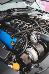 Detailed view of a modern car engine featuring a turbocharger, highlighting automotive engineering.