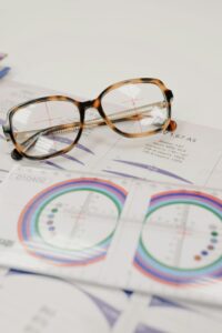 From above of lens ruler with illustration on paper with text and stylish spectacles on white background