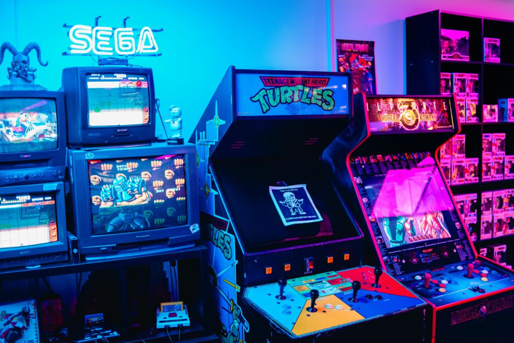 A vibrant retro arcade room featuring classic gaming machines and colorful neon lighting.
