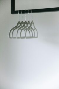 Minimalist photo of empty clothes hangers on a rack, highlighting simplicity.