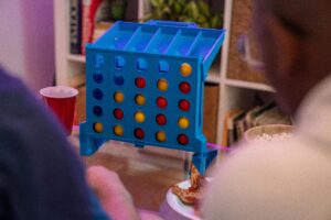 A group of friends enjoying a board game together indoors around a table.