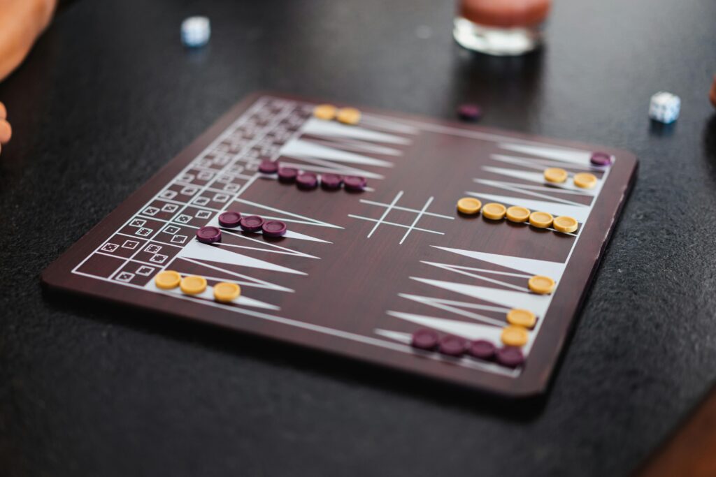 An overhead view of a backgammon game in progress with dice and checker pieces.