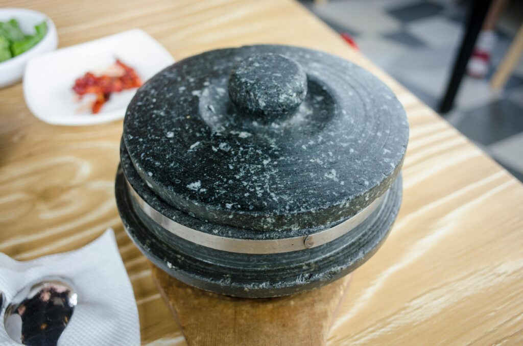 High angle view of a traditional stone kitchenware on a wooden table, perfect for cooking themes.
