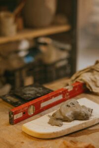 Close-up of clay and tools in an artisan pottery workshop, showcasing traditional craftsmanship.