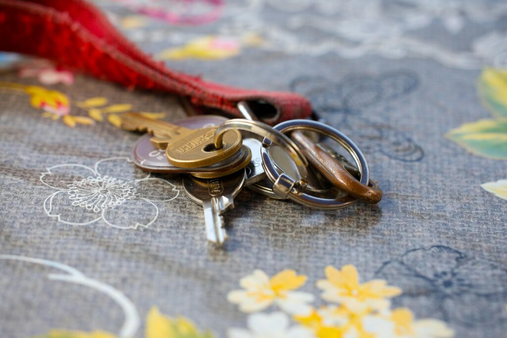 A set of keys lying on a floral-patterned fabric background. Ideal for security themes.